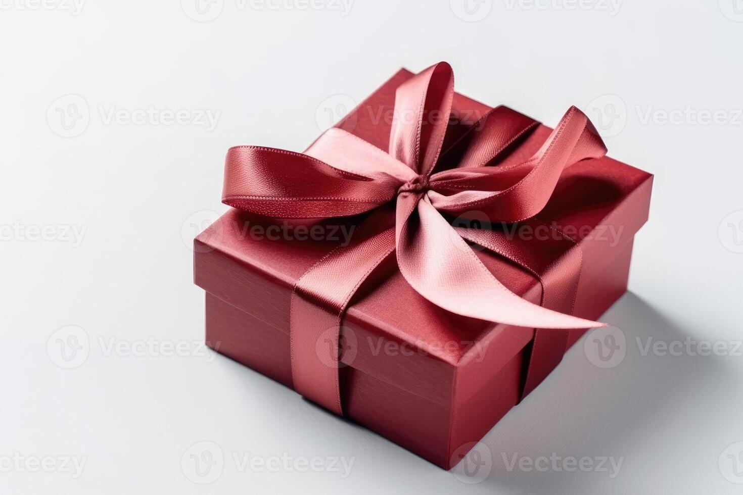 Gift box with satin ribbon and bow on white background photo