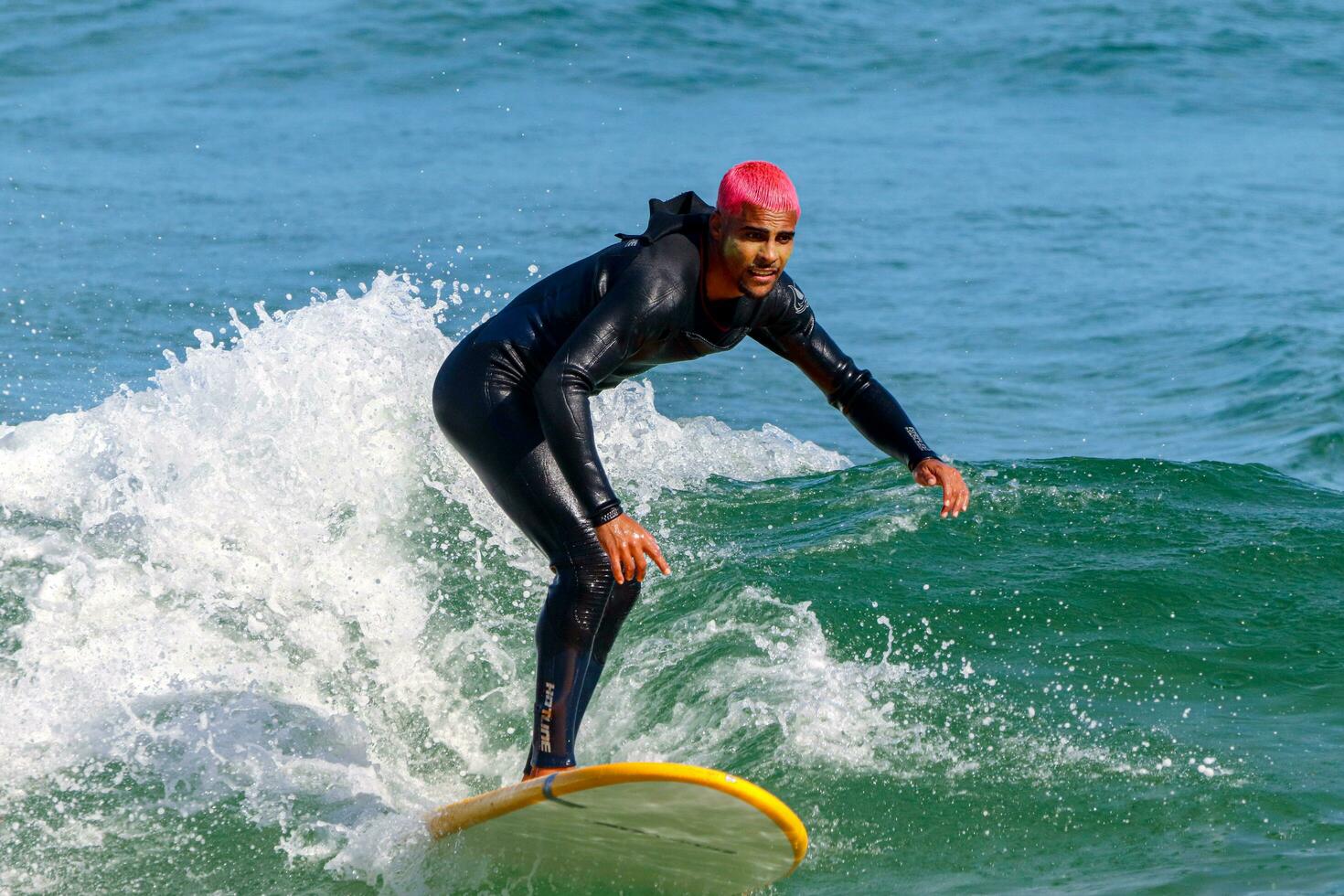 Rio de Janeiro, RJ, Brazil, 05.08.2023 - Surfers riding waves on Arpoador Beach, Ipanema photo
