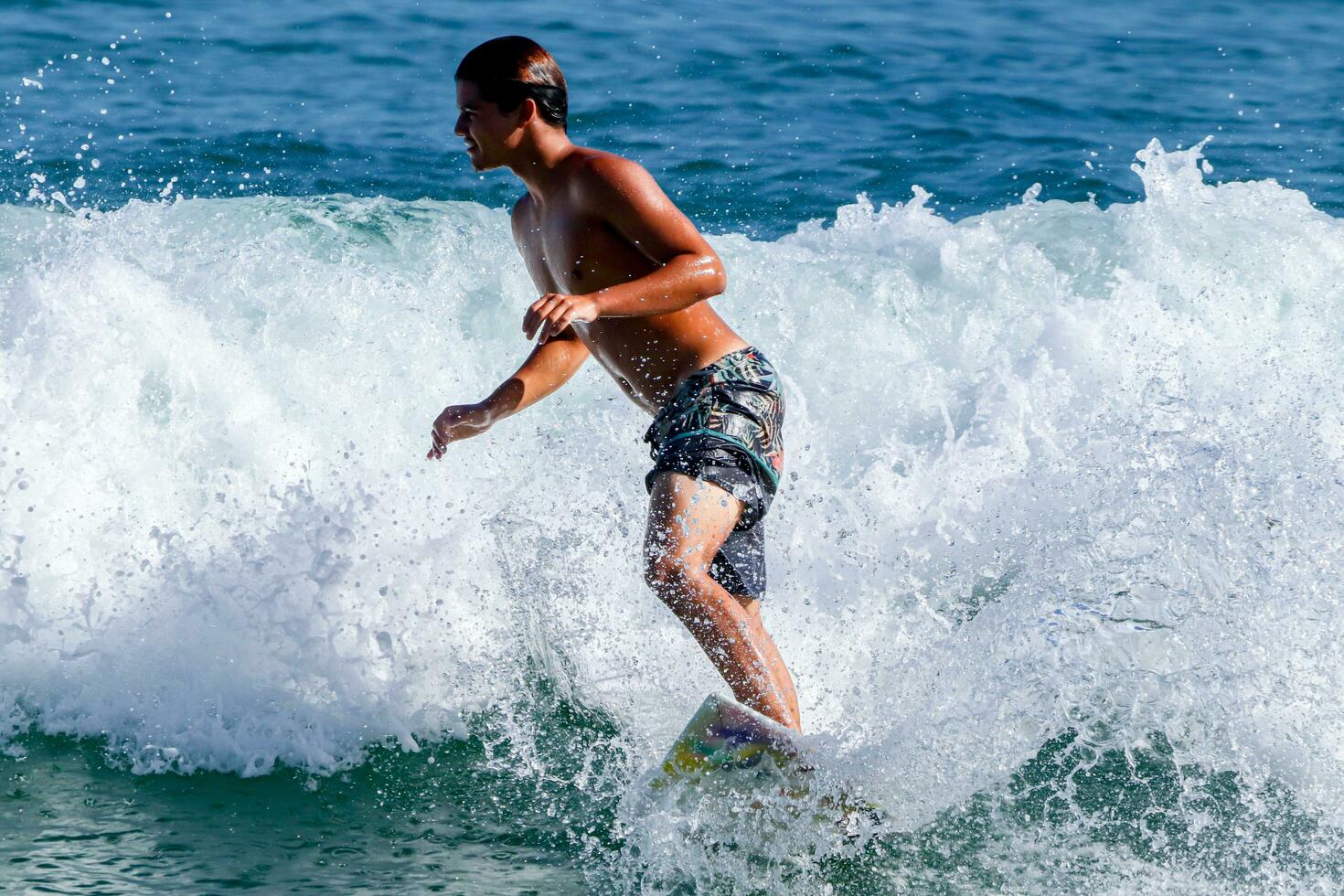 Rio de Janeiro, RJ, Brazil, 05.08.2023 - Surfers riding waves on Arpoador Beach, Ipanema photo