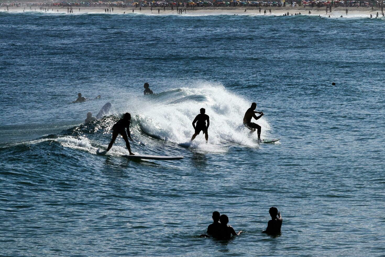 Rio de Janeiro, RJ, Brazil, 05.08.2023 - Surfers riding waves on Arpoador Beach, Ipanema photo