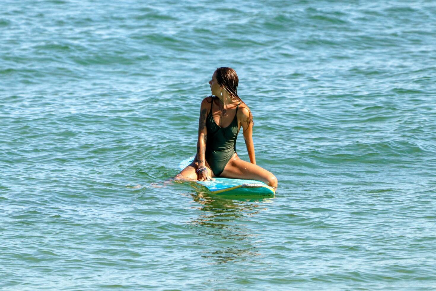 Rio de Janeiro, RJ, Brazil, 05.08.2023 - Surfers riding waves on Arpoador Beach, Ipanema photo