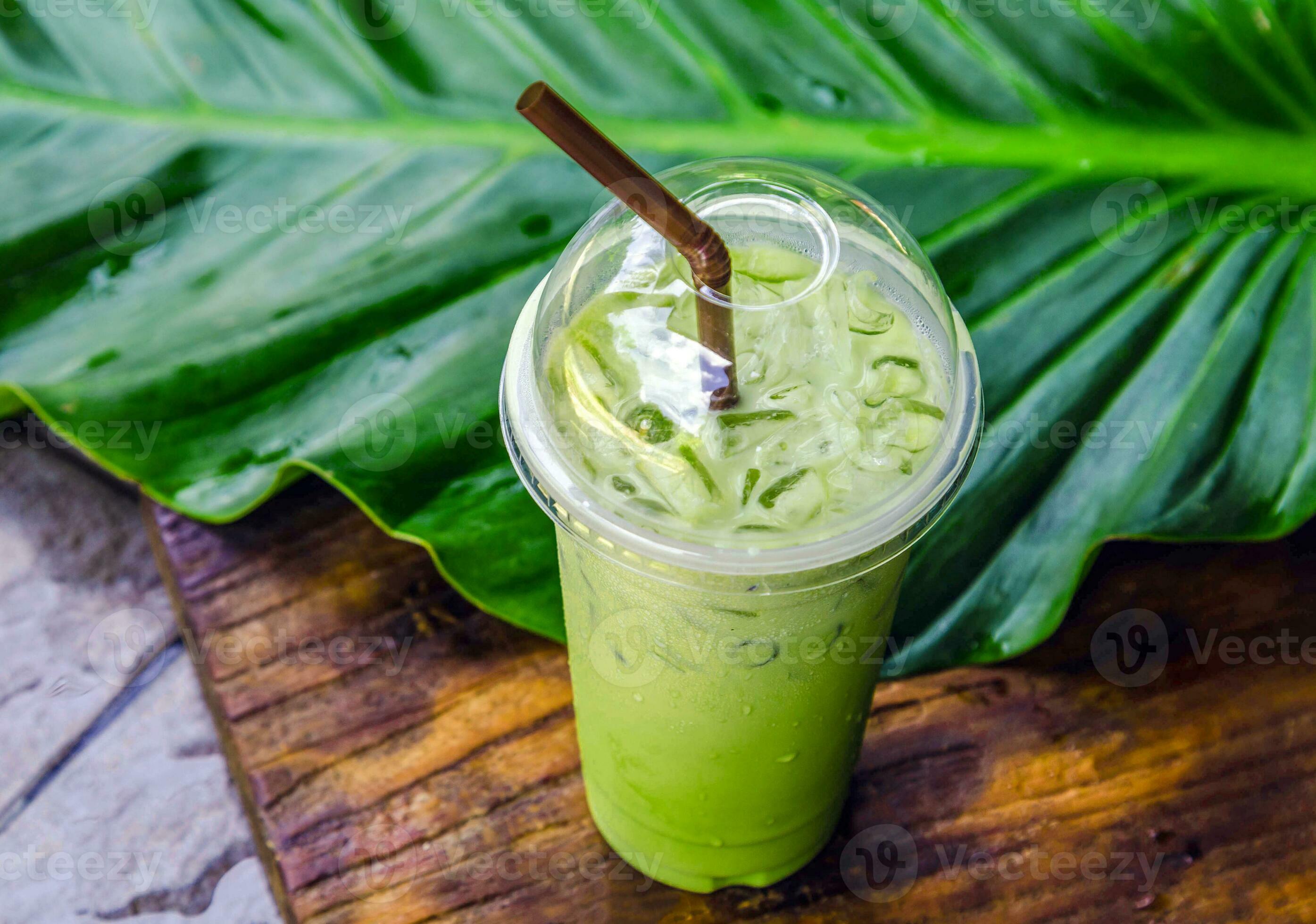 iced matcha latte, green tea with milk in a plastic glass with ice
