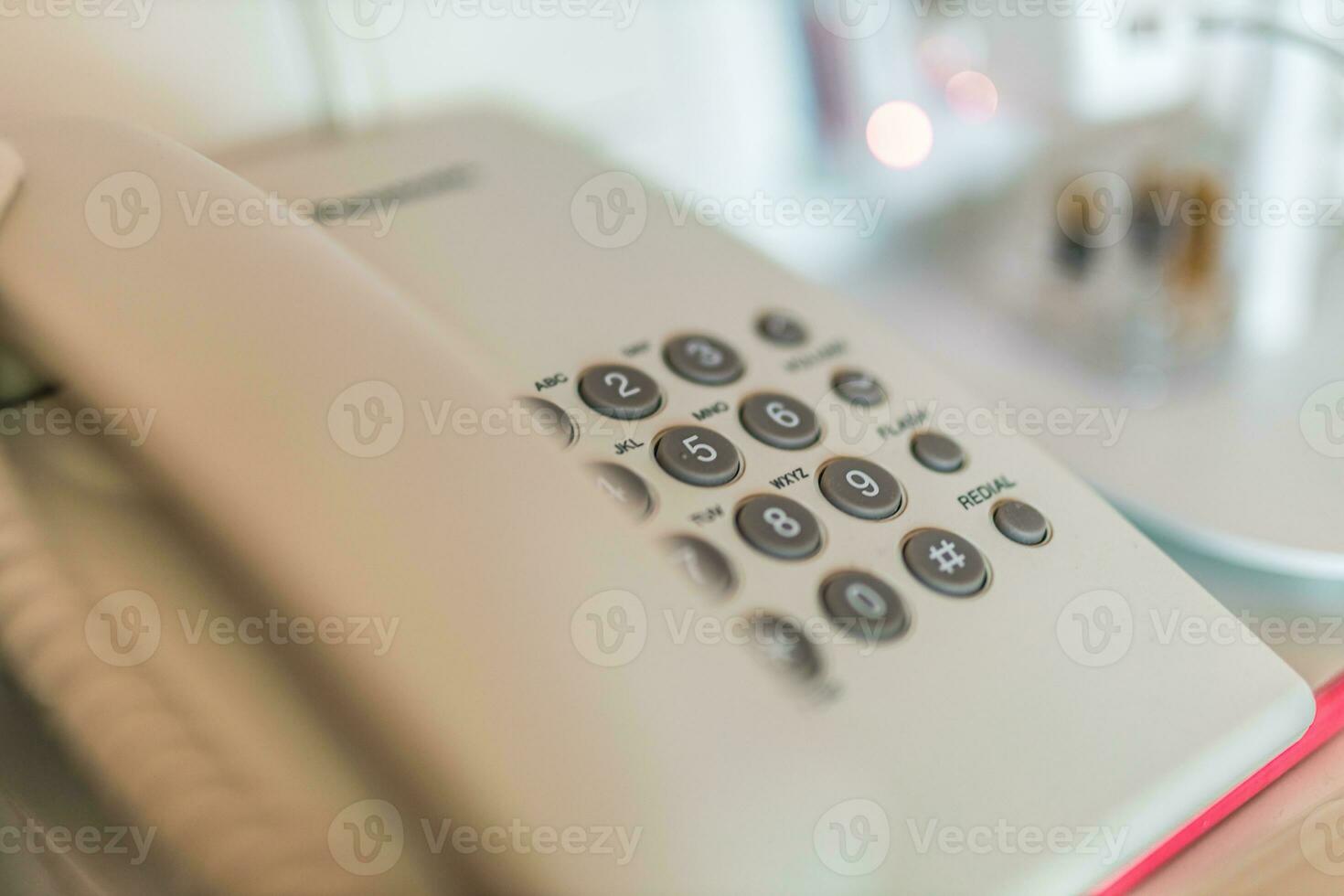 Closeup soft focus on telephone devices at office desk. Communication technology concept photo