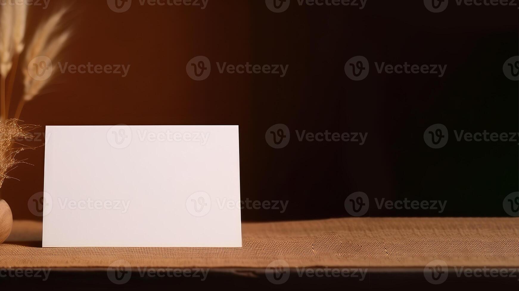 Blank White Invitation Card Mockup and Closeup Dried Grass Pot Decoration on Burlap Cover Table. . photo