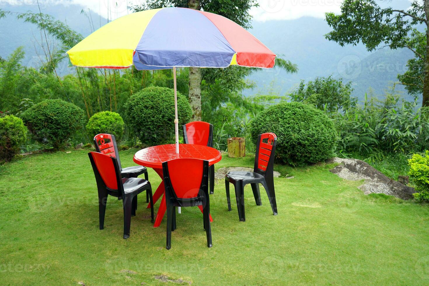 Sitting Arrangement wih Chair and Table at the top view point of Mountain Village Lungchok with Green Grass photo