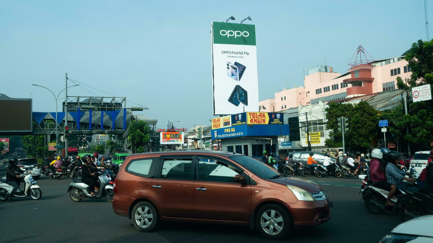 Bogor, West Java, Indonesia, May 2 2023 - Very heavy traffic of cars and motorcycle at one of the intersections of Bogor city during a sunny day. photo