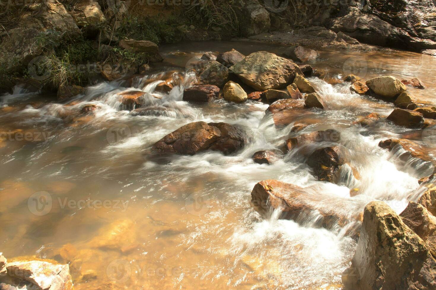 The small river known as Rio dos Goianos that flows into the Waterfall Known as Cachoeira Boqueirao in Paranoa, Brazil, near Brasilia photo