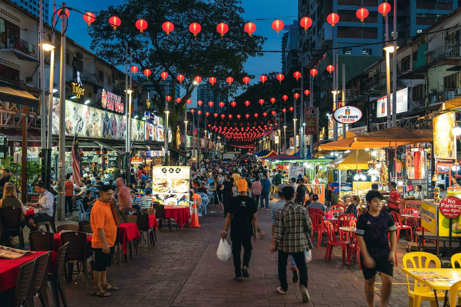 Jalan Alor food street in kuala lumpur, malaysia, was once known as a red light district and remnants of those activities still exist. the stalls are parked all along the street. photo