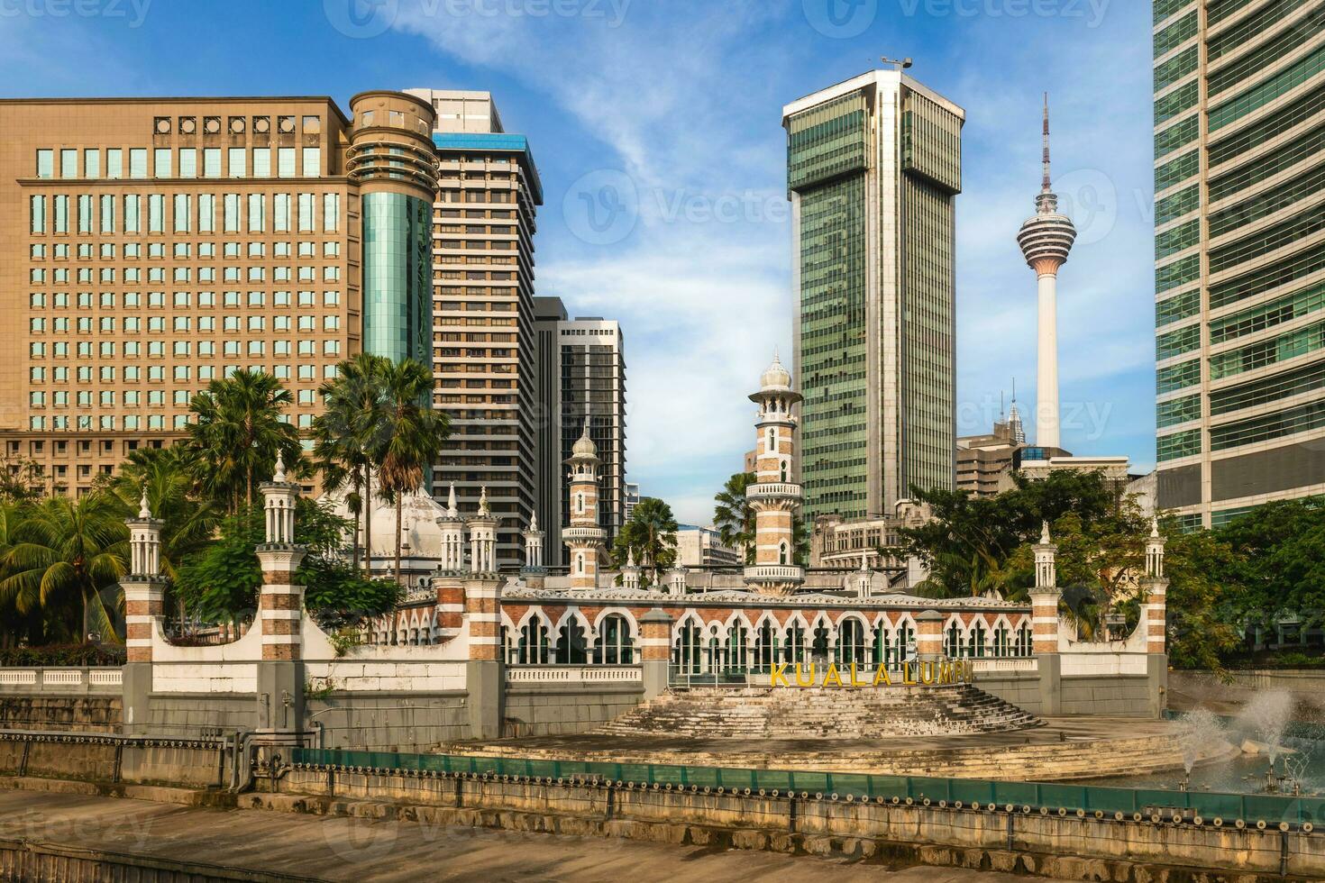 jamek mosque and kuala lumpur tower at the river of life in Kuala Lumpur, Malaysia photo