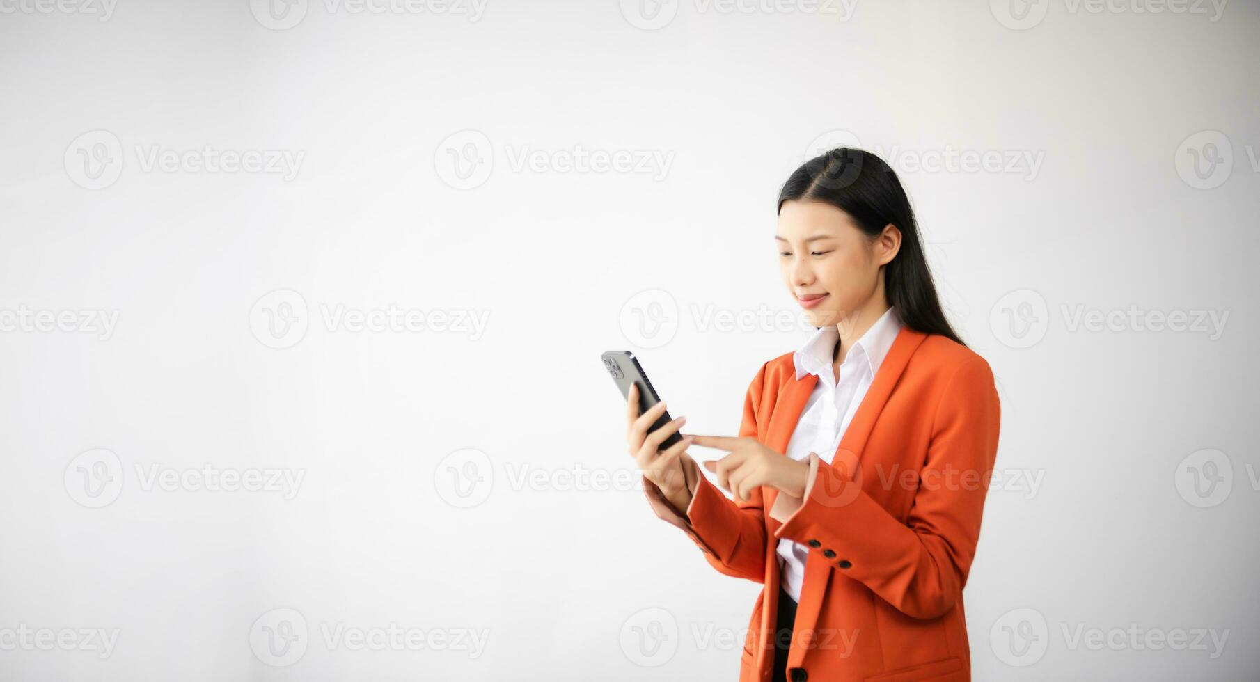 Portrait photo of young beautiful Asian woman feeling happy and holding smart phone, tablet and laptop with black empty screen on white background can use for advertising or product concept.