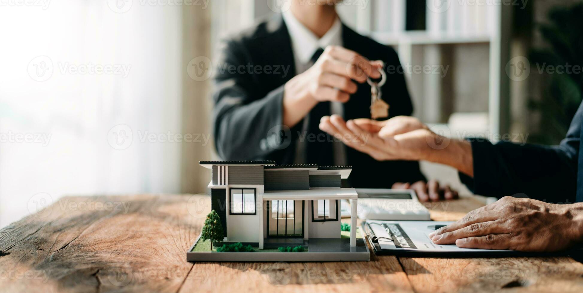 Signing a contract. Client and broker agent, lease agreement, successful deal and  Young business sitting at the desk in office photo