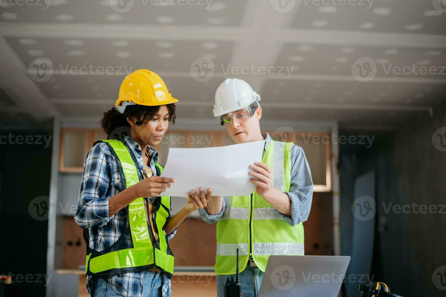 Engineers are discussing data working and laptop or tablet with architectural project at new construction site on big project. photo