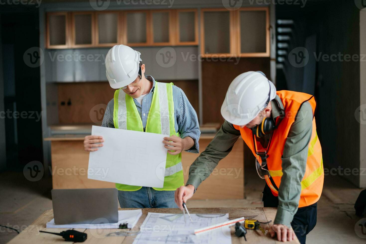 Engineers are discussing data working and laptop or tablet with architectural project at new construction site on big project. photo