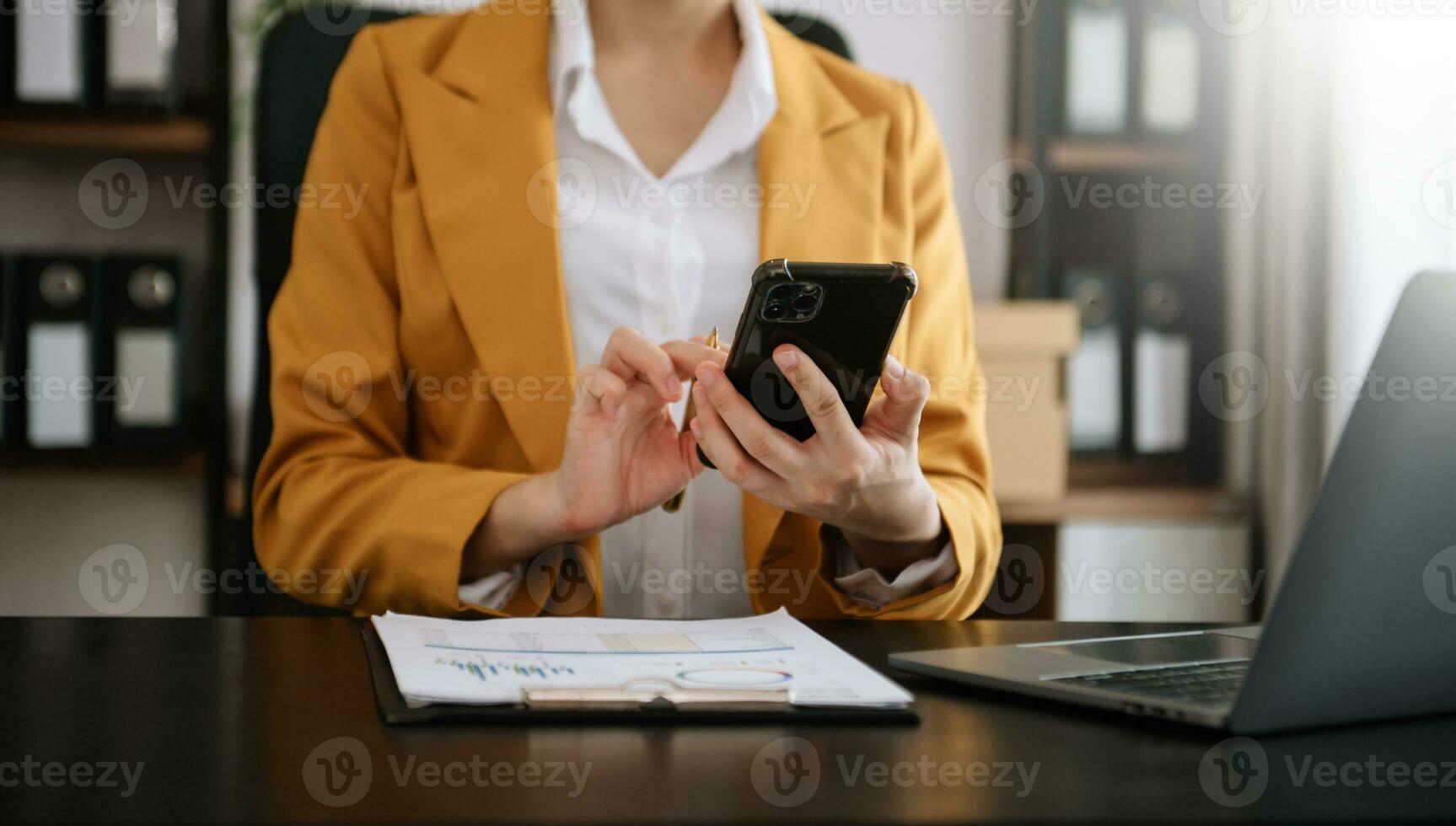 Businesswoman hand working digital marketing media in virtual screen with mobile phone and modern compute with diagram at office photo
