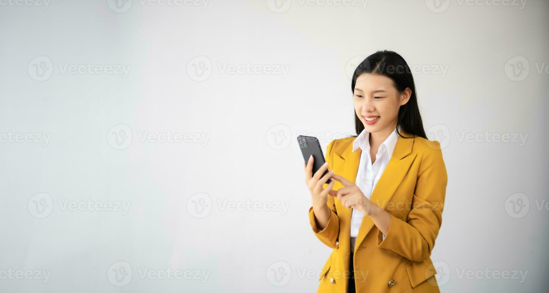 Portrait photo of young beautiful Asian woman feeling happy and holding smart phone, tablet and laptop with black empty screen on white background can use for advertising or product concept.