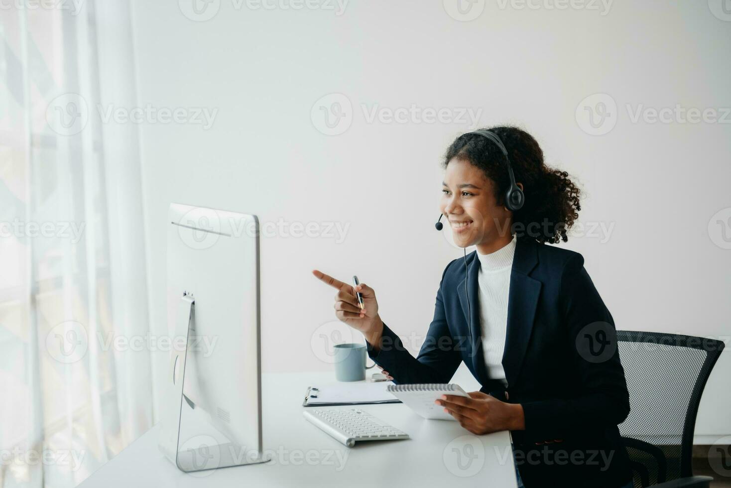 Serious call center operator in wireless headset talking with customer, woman in headphones with microphone consulting client on phone in customer support service photo