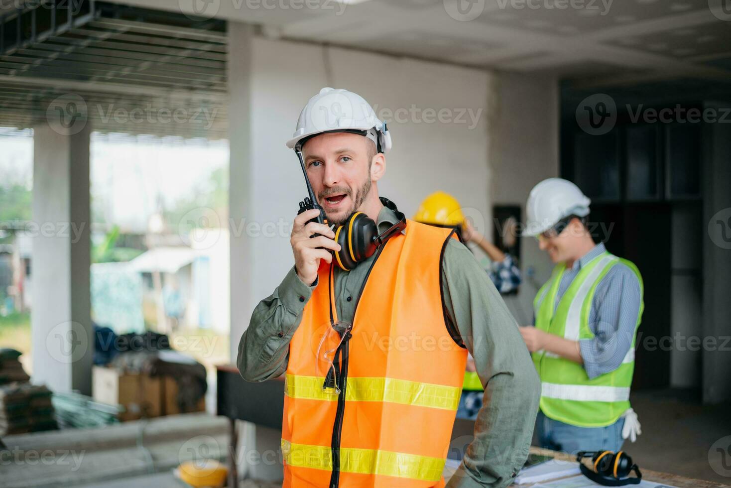 Engineers are discussing data working and laptop or tablet with architectural project at new construction site on big project. photo