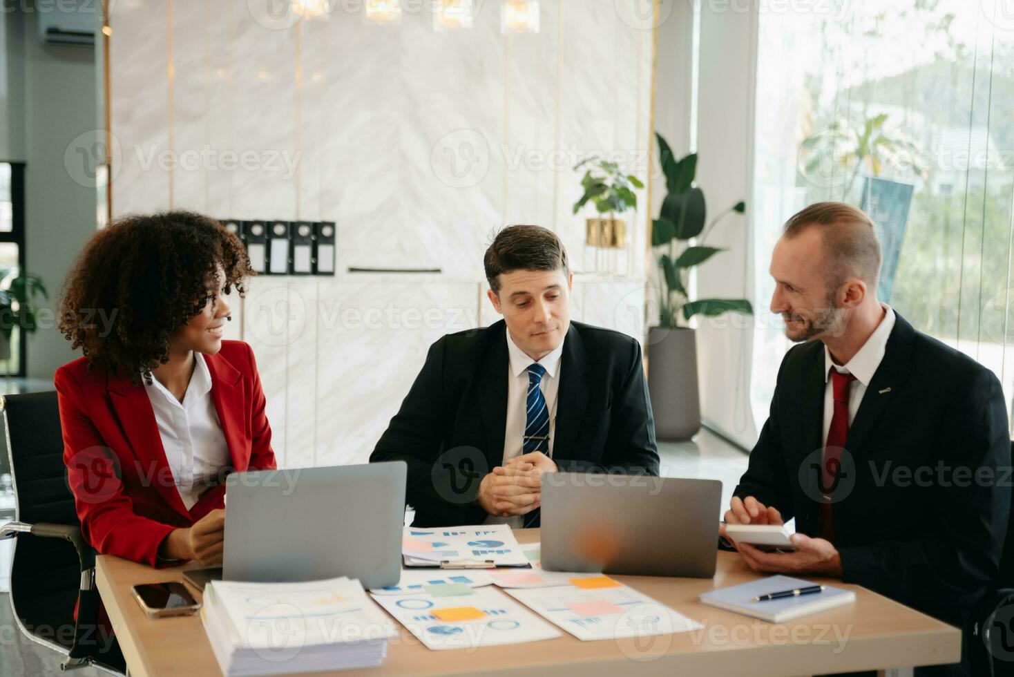 Group of young business people discussing business plan at modern startup in creative business discussing work modern office building photo