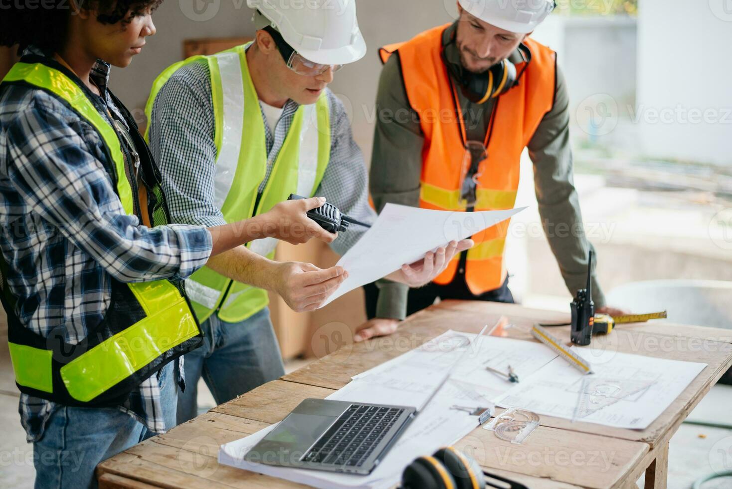 Engineers are discussing data working and laptop or tablet with architectural project at new construction site on big project. photo