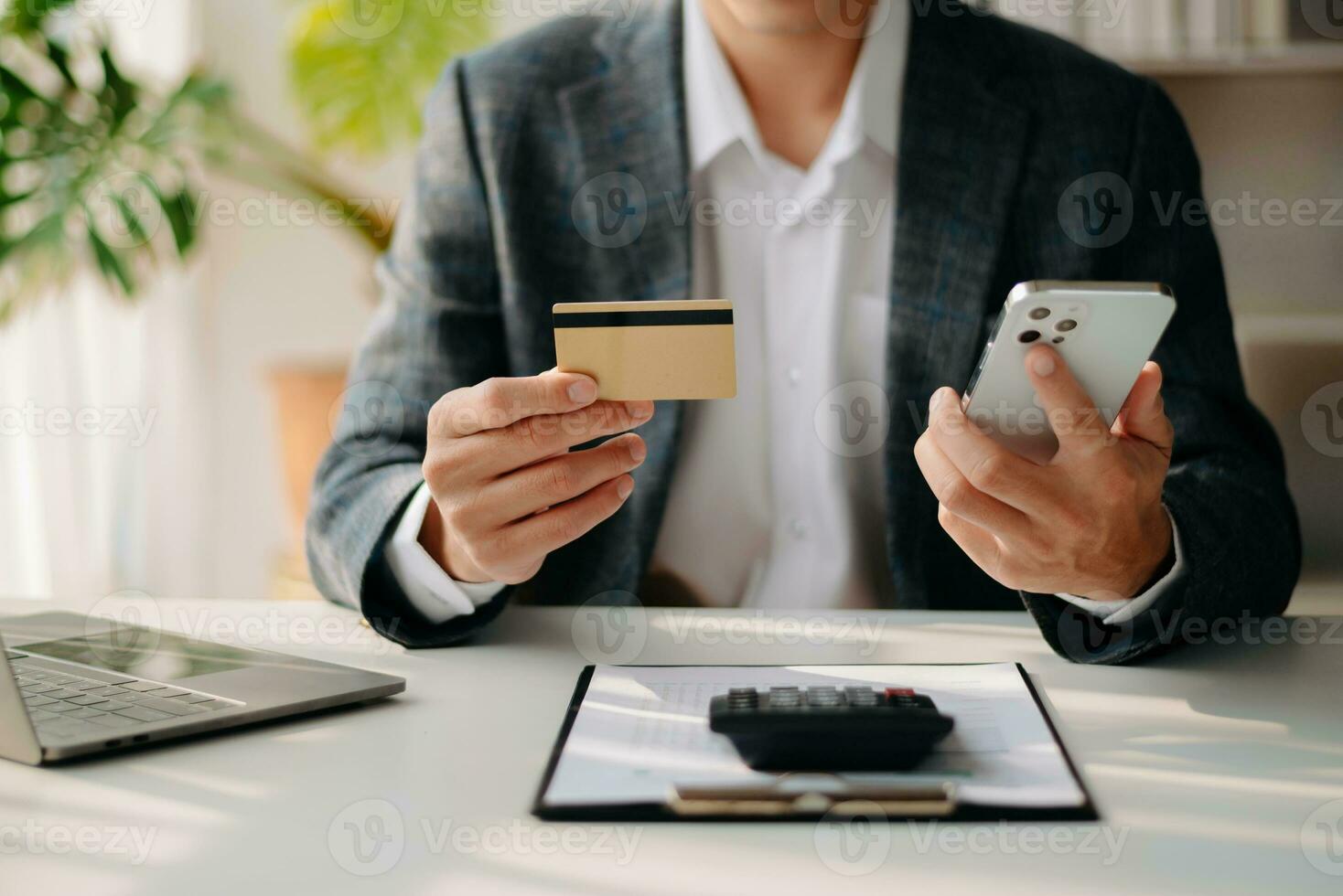 Man using smart phone for mobile payments online shopping,omni channel,sitting on table photo