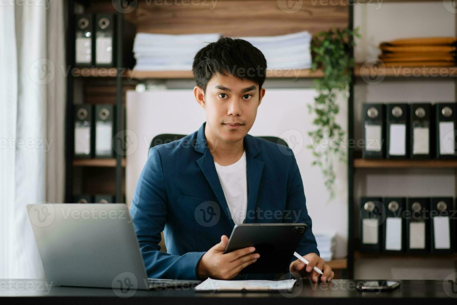 business man executive manager looking at laptop watching online webinar training or having virtual meeting video conference doing market research working photo