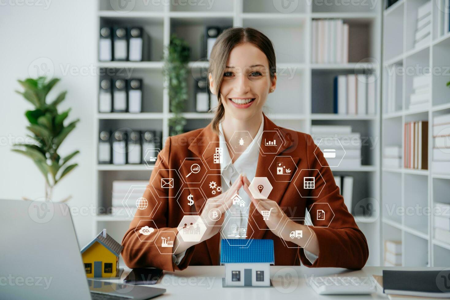 Female real estate agent is use hands to protect red roof for the concept of real estate investment about house trading, purchase at desk in office photo