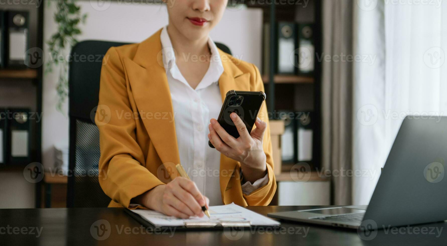 Businesswoman hand working digital marketing media in virtual screen with mobile phone and modern compute with diagram at office photo