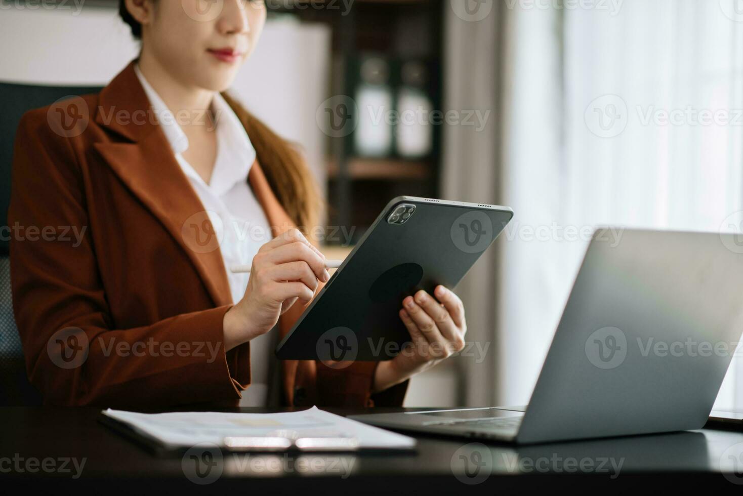 Businesswoman hand working digital marketing media in virtual screen with mobile phone and modern compute with diagram at office photo