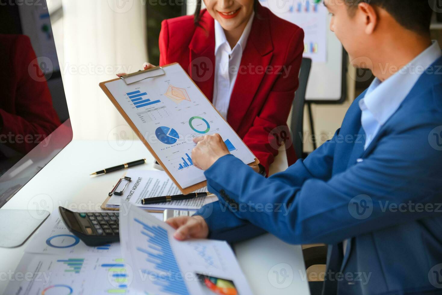 Business People Talking Discussing with financial document data charts and graphs Team business meeting with smart phone and laptop and digital tablet computer photo