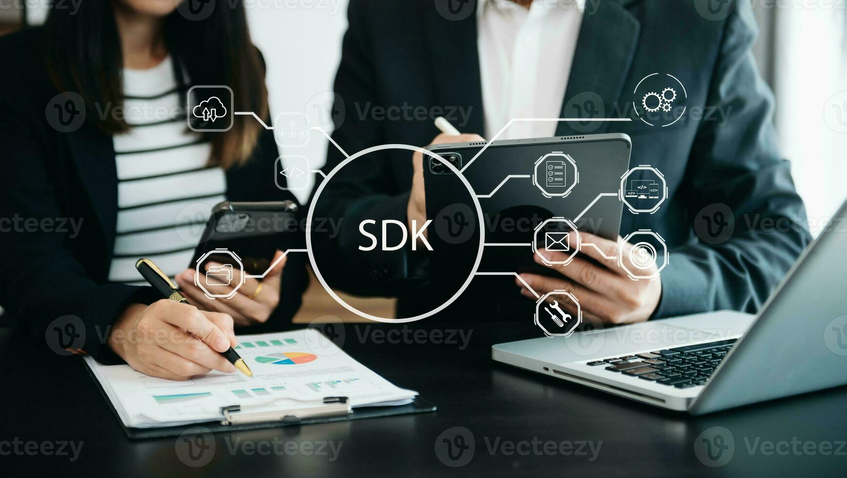 SDK  Software development kit programming language technology concept, Person typing laptop computer and tablet with SDK icon on virtual screen. in office photo