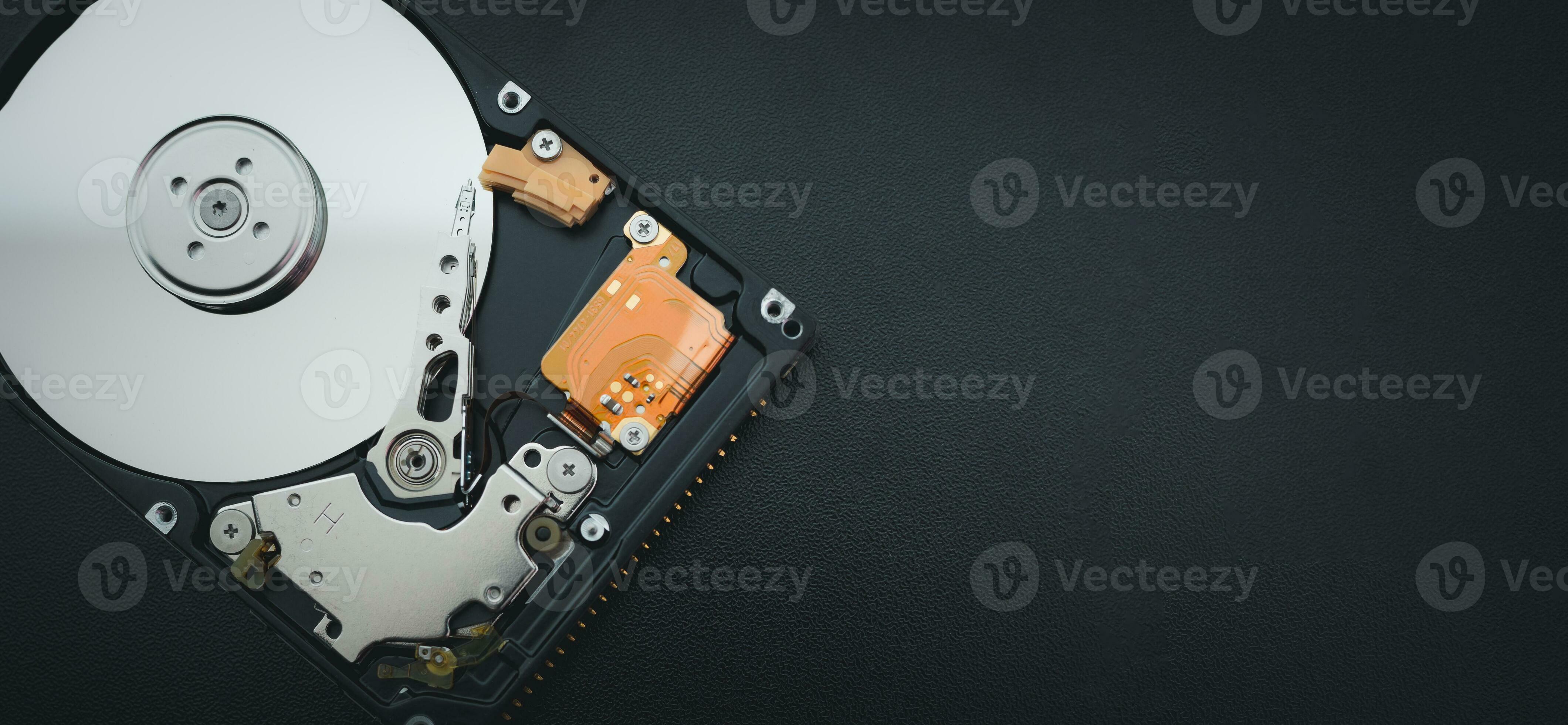 open hard disk drive HDD of computer or laptop lies on dark matte surface. 24674613 Stock Photo