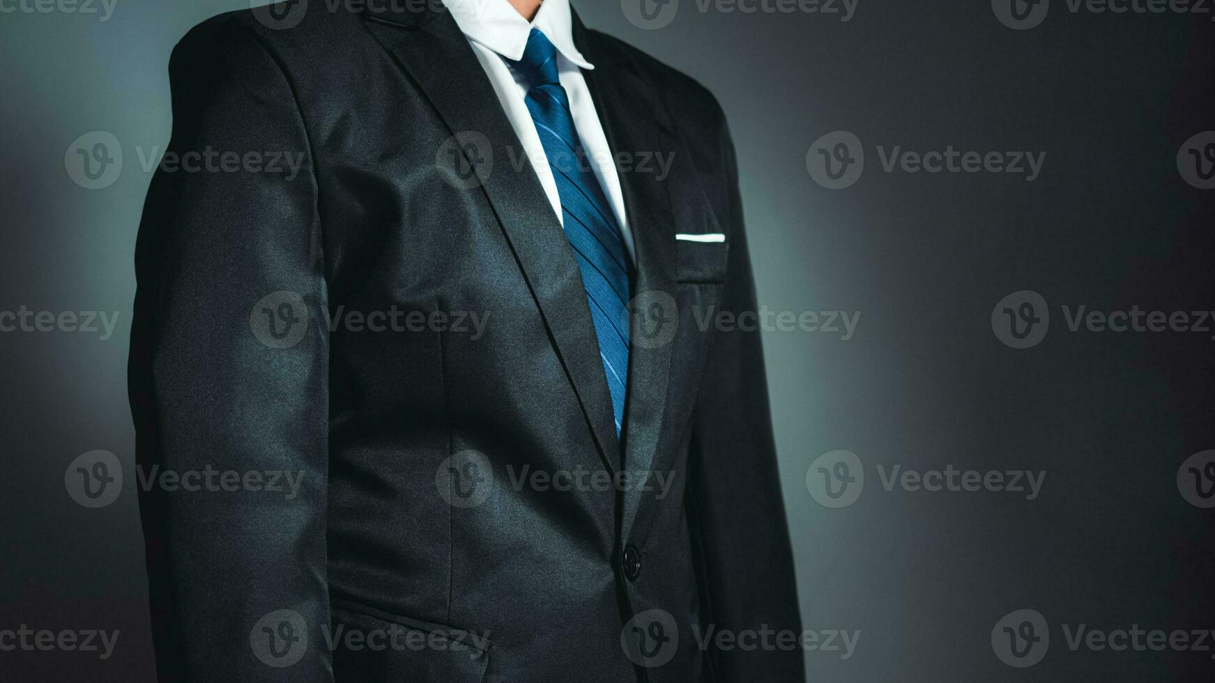 businessman standing on dark gradient background. business concept. suit. photo