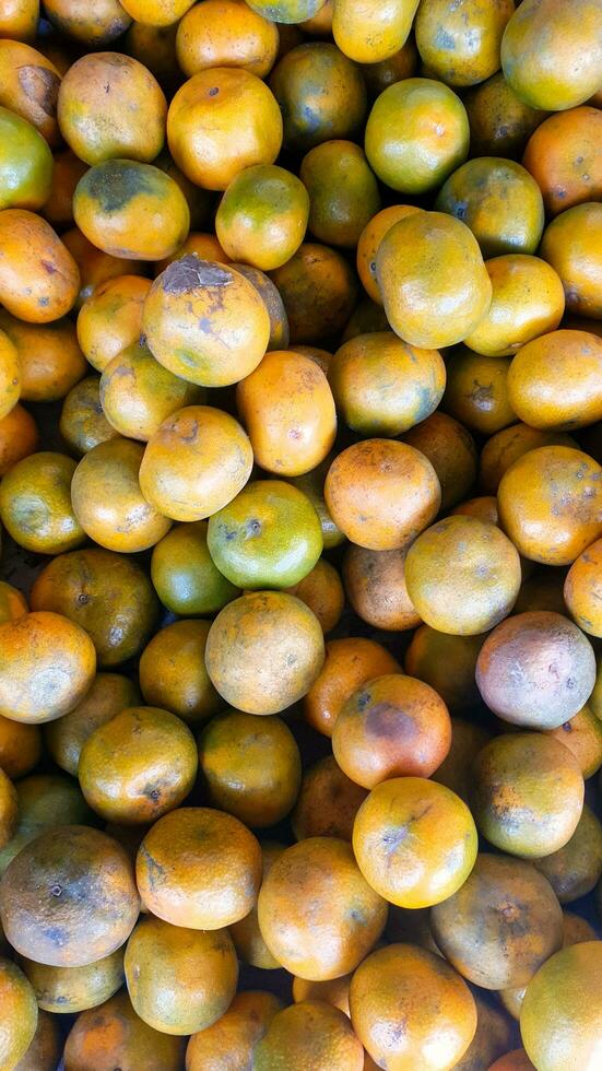 Piles of Indonesian local oranges at a Jakarta traditional market photo
