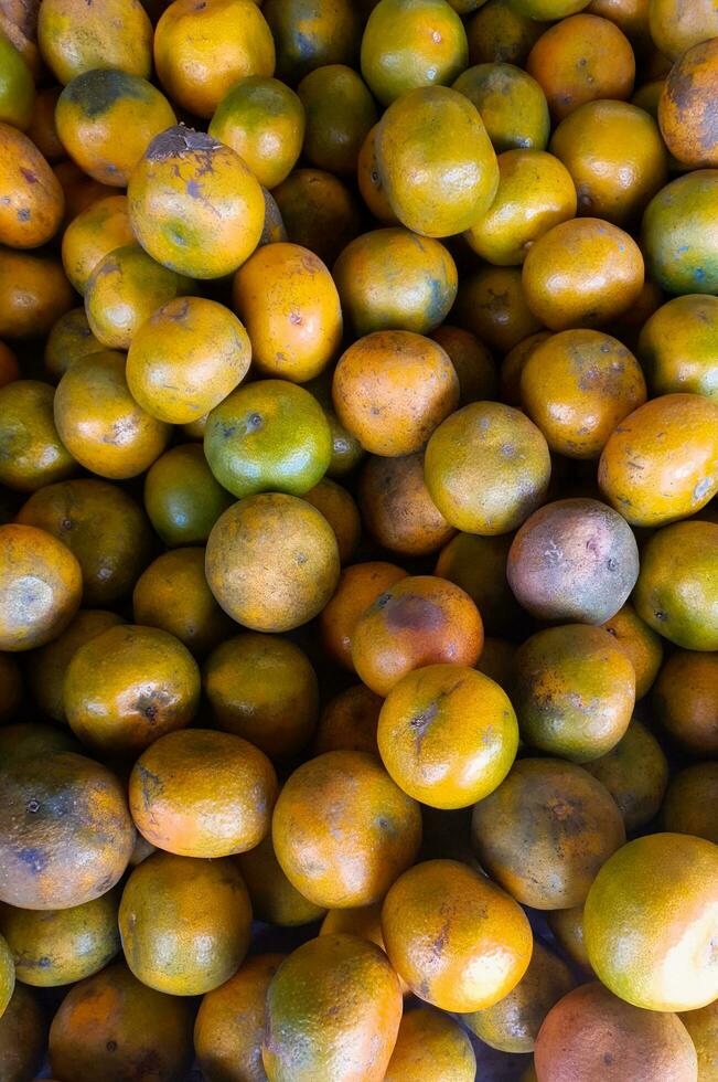 Piles of Indonesian local oranges at a Jakarta traditional market photo