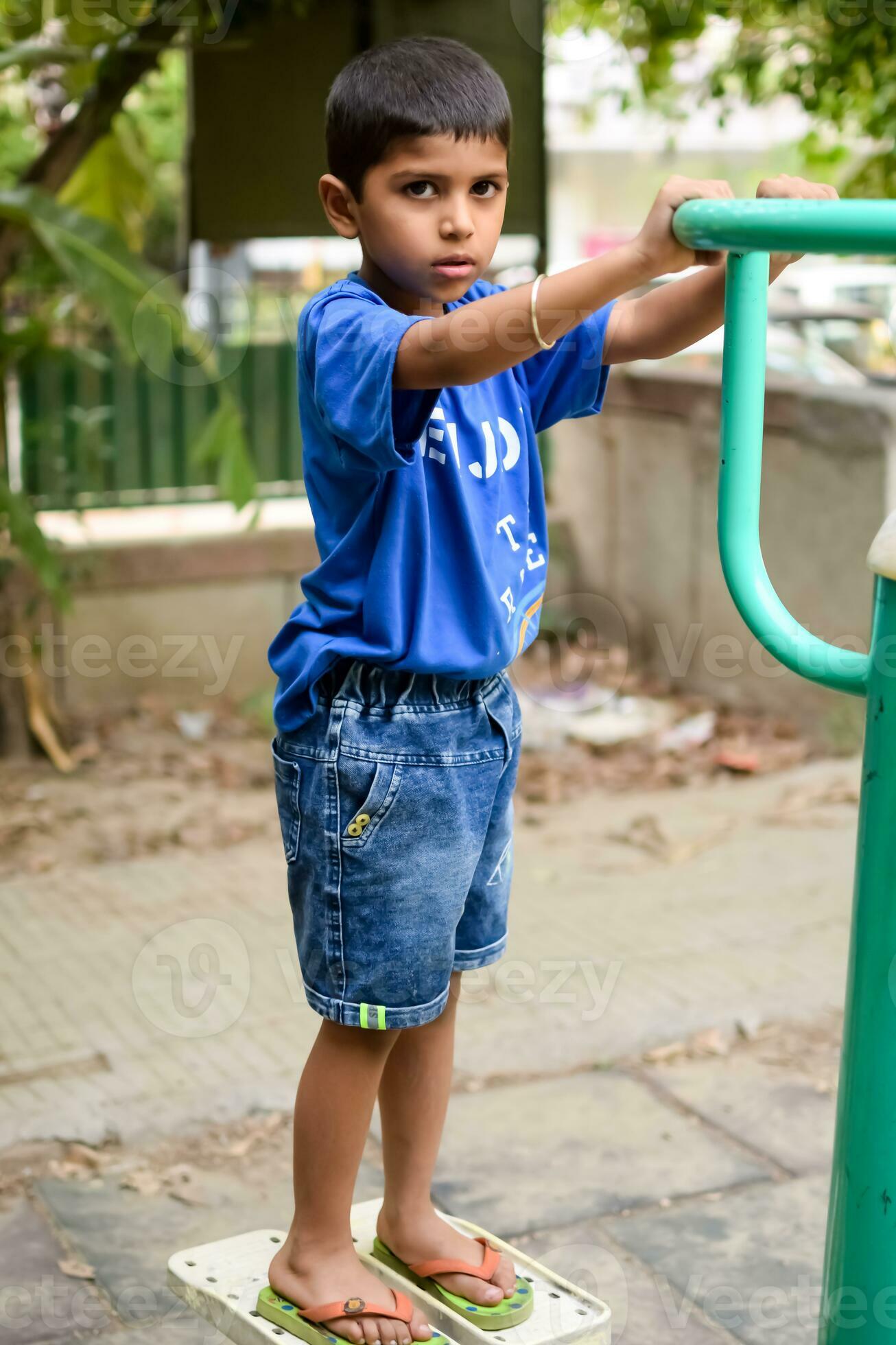 Asian boy doing routine exercise in society park during the morning time.  Cute little kid exercise and gym to keep himself fit for life. Child  exercise outdoor shoot 24677565 Stock Photo at