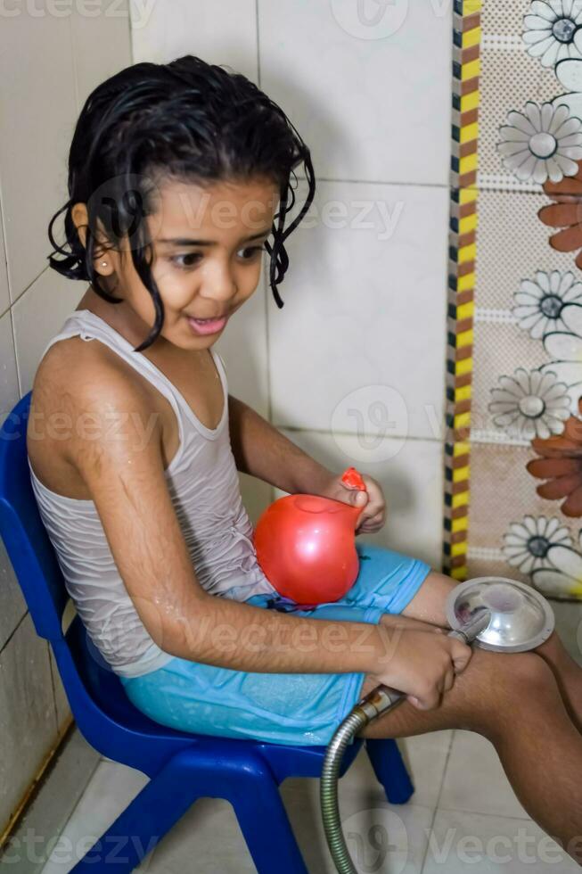 Cute Indian Girl having bath during the summer vacation season, Cute Asian child washing in a bathroom, Kid Bathing lifestyle concept photo