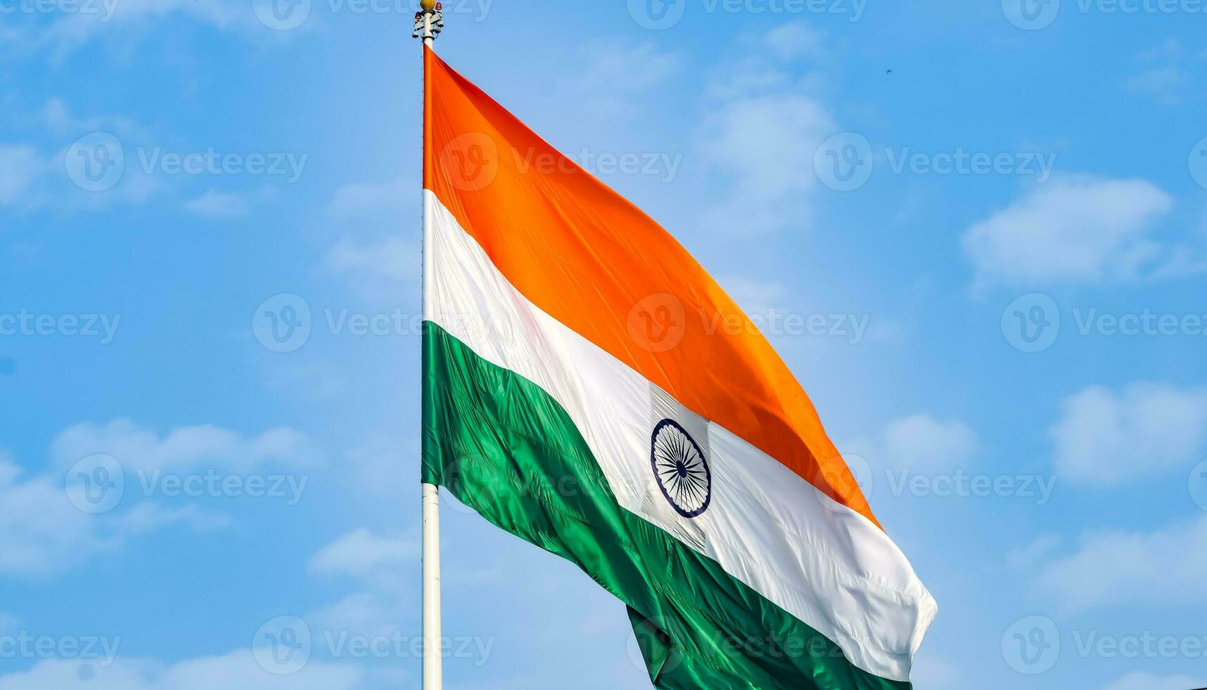 India flag flying high at Connaught Place with pride in blue sky, India flag fluttering, Indian Flag on Independence Day and Republic Day of India, tilt up shot, Waving Indian flag, Har Ghar Tiranga photo