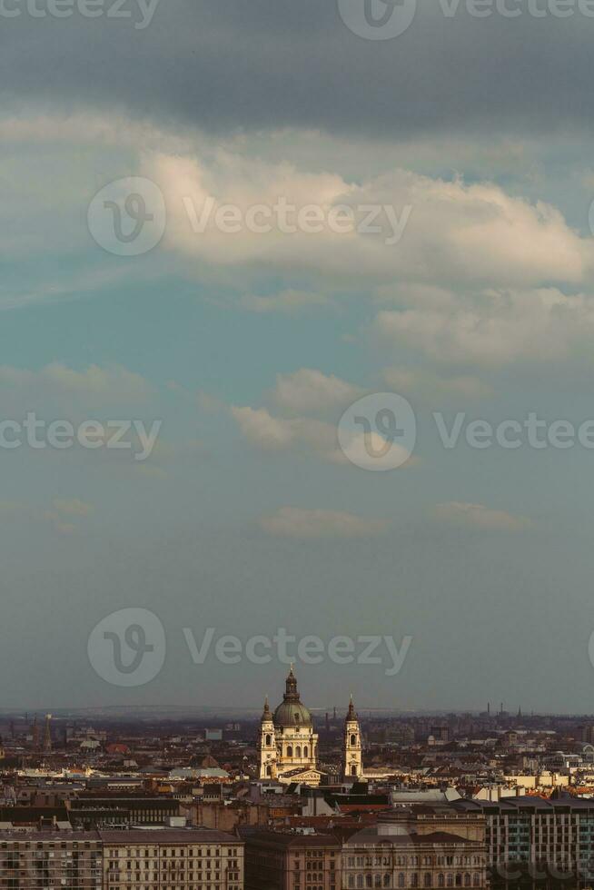 The view of Budapest with the illuminated Szent cathedral under the blue sky during the afternoon photo