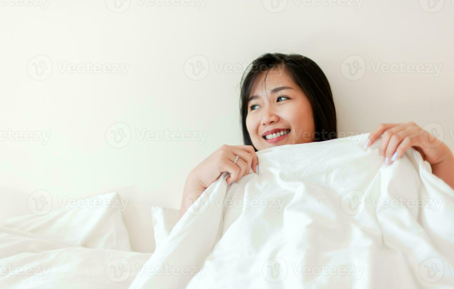 Wake up happy in the morning in bed Enough rest, full sleep, and a smile full of happiness. happy bedroom photo