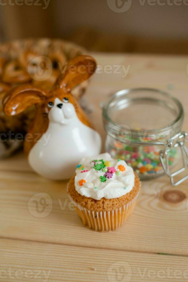 little Easter cake on the wooden table of the house photo