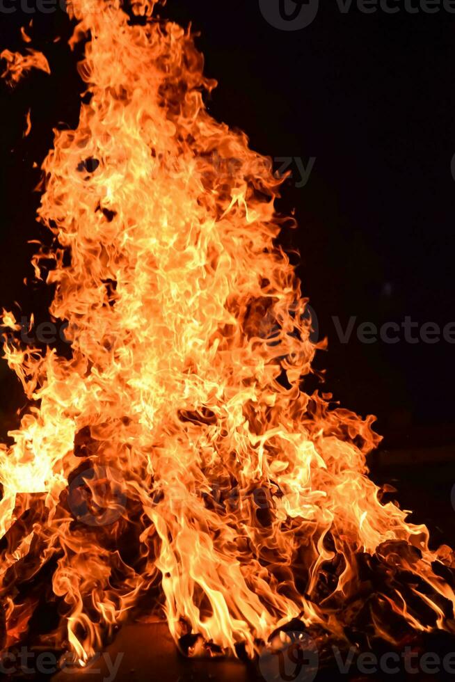 Fire flames on black background, Blaze fire flame texture background, Beautifully, the fire is burning, Fire flames with wood and cow dung bonfire photo