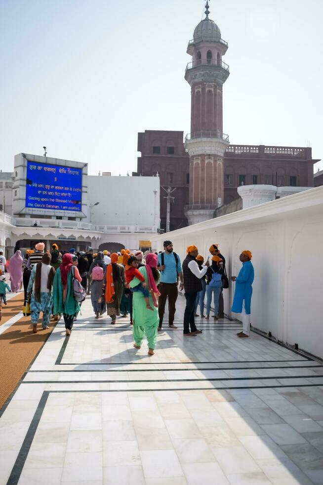 Amritsar, India - February 26 2023 - Unidentified devotees from various parts at Golden Temple - Harmandir Sahib in Amritsar, Punjab, India, Famous indian sikh landmark, Golden Temple photo