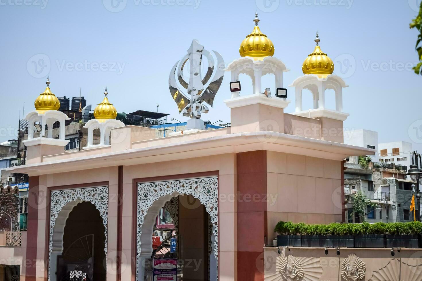 Khanda Sikh holy religious symbol at gurudwara entrance with bright blue sky image is taken at Sis Ganj Sahib Gurudwara in Chandni Chowk, opposite Red Fort in Old Delhi India photo