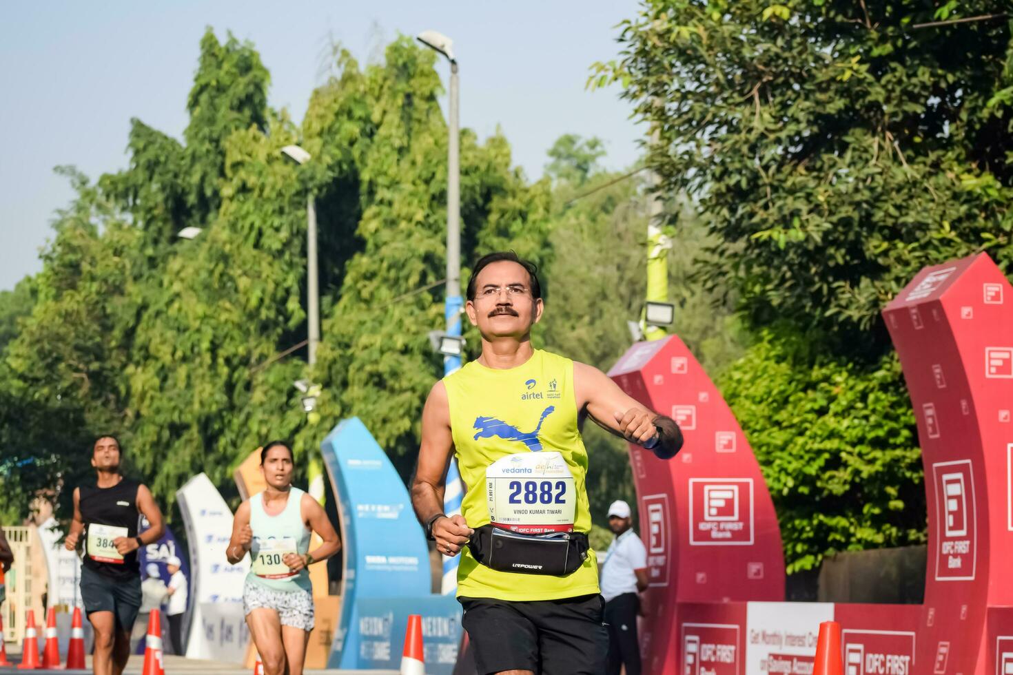 New Delhi, India - April 16 2023 - Vedanta Delhi Half Marathon race after covid in which marathon participants about to cross the finish line, Delhi Half Marathon 2022 photo