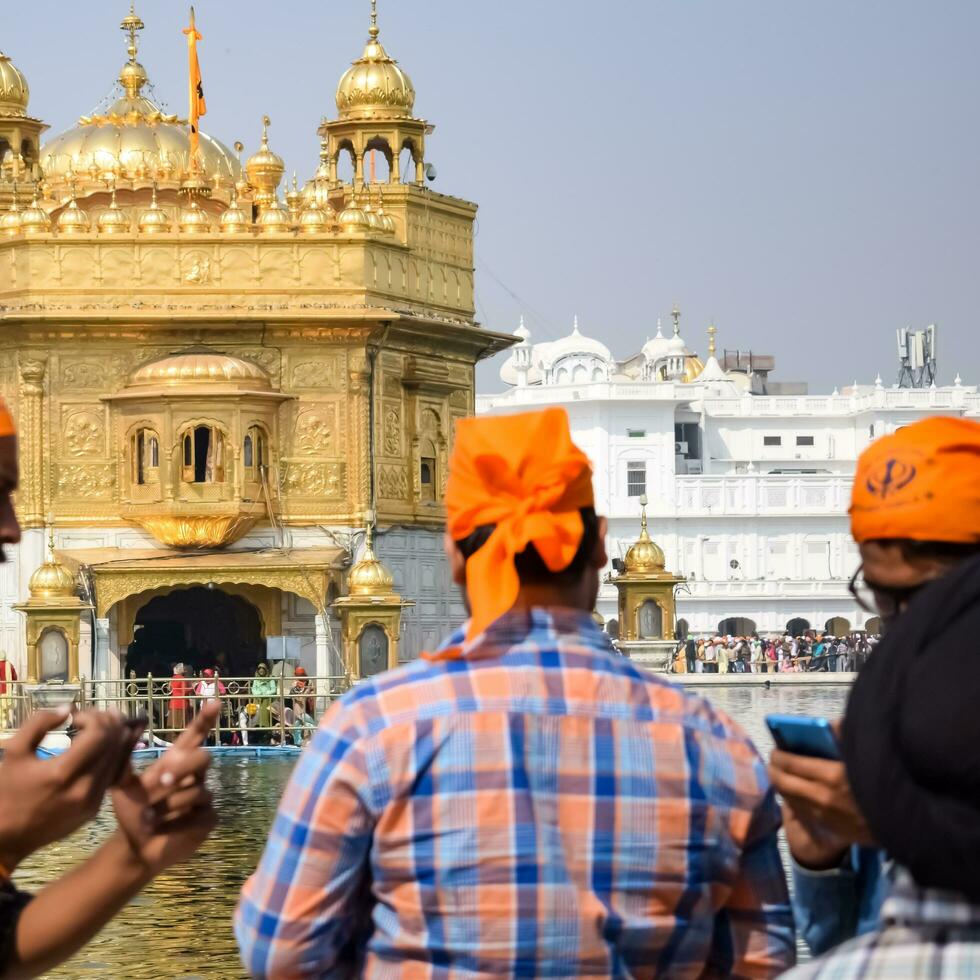 Amritsar, India - February 26 2023 - Unidentified devotees from various parts at Golden Temple - Harmandir Sahib in Amritsar, Punjab, India, Famous indian sikh landmark, Golden Temple photo