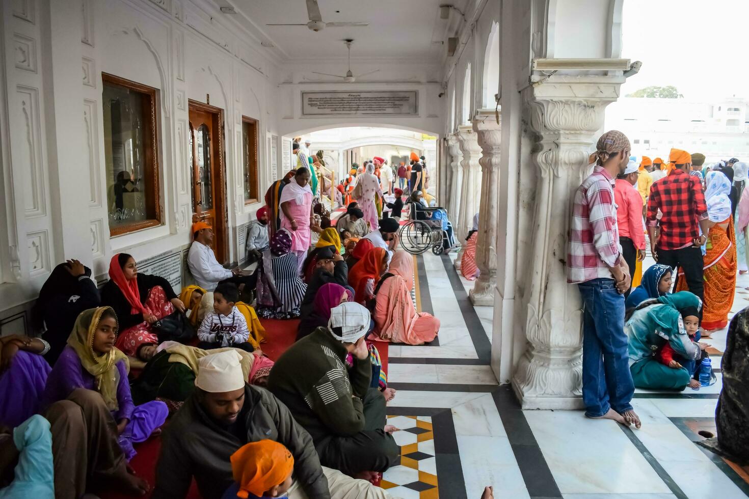 Amritsar, India - February 26 2023 - Unidentified devotees from various parts at Golden Temple - Harmandir Sahib in Amritsar, Punjab, India, Famous indian sikh landmark, Golden Temple photo