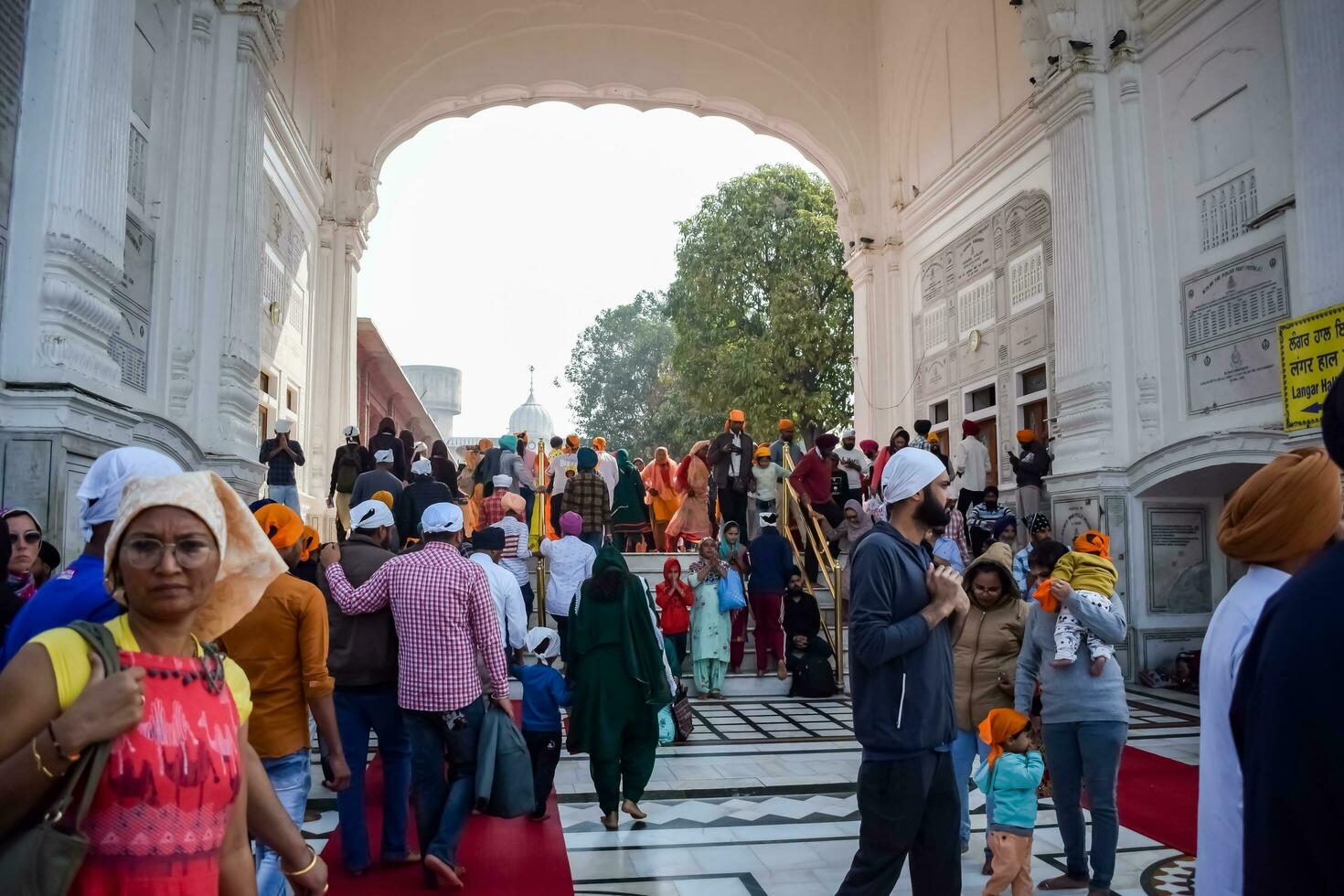 Amritsar, India - February 26 2023 - Unidentified devotees from various parts at Golden Temple - Harmandir Sahib in Amritsar, Punjab, India, Famous indian sikh landmark, Golden Temple photo
