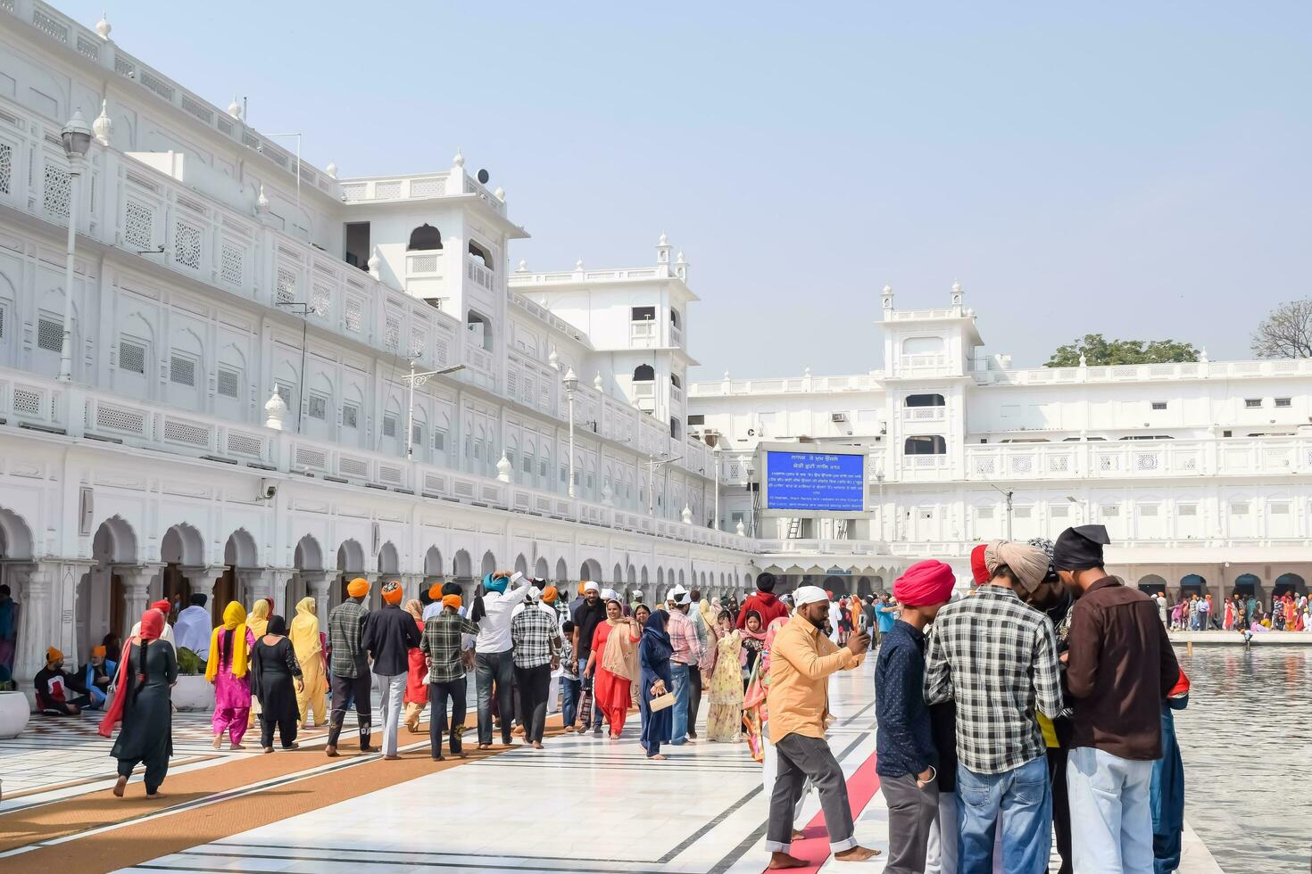 Amritsar, India - February 26 2023 - Unidentified devotees from various parts at Golden Temple - Harmandir Sahib in Amritsar, Punjab, India, Famous indian sikh landmark, Golden Temple photo