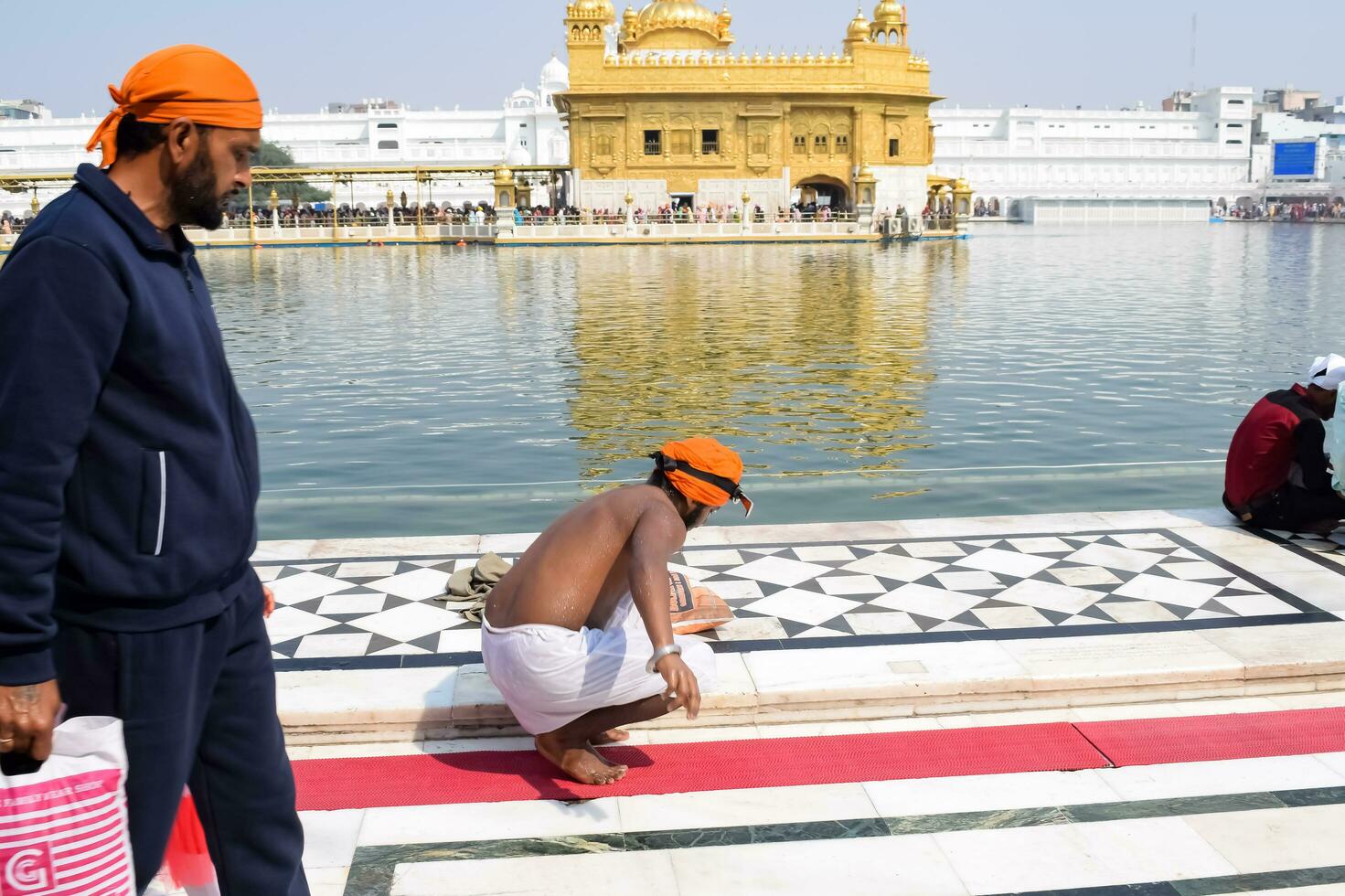 Amritsar, India - February 26 2023 - Unidentified devotees from various parts at Golden Temple - Harmandir Sahib in Amritsar, Punjab, India, Famous indian sikh landmark, Golden Temple photo