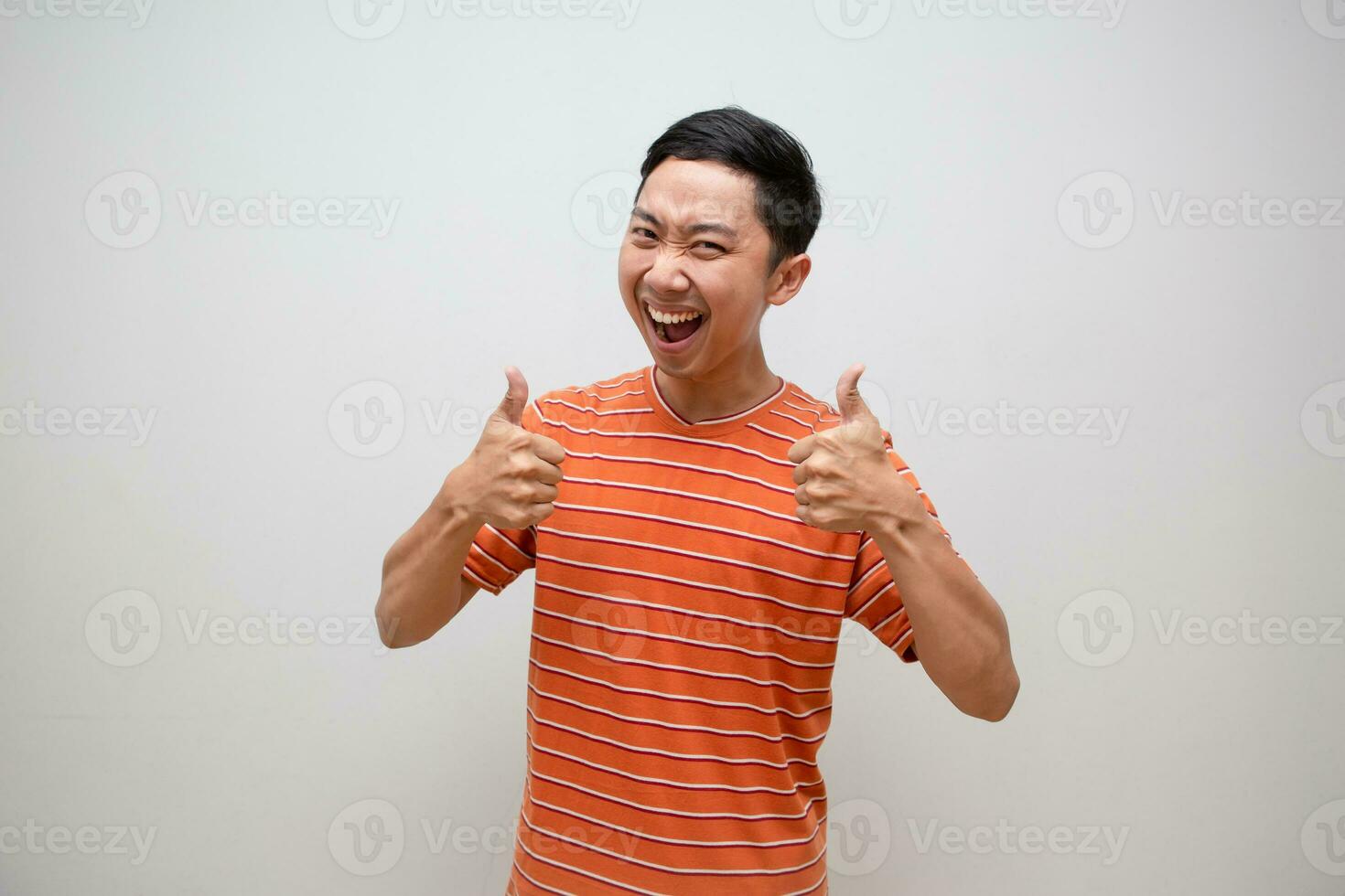 Cheerful asian man orange shirt show thumb up with happy smile with successful isolated photo